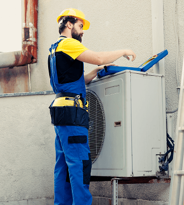 Service technician working on outdoor AC unit